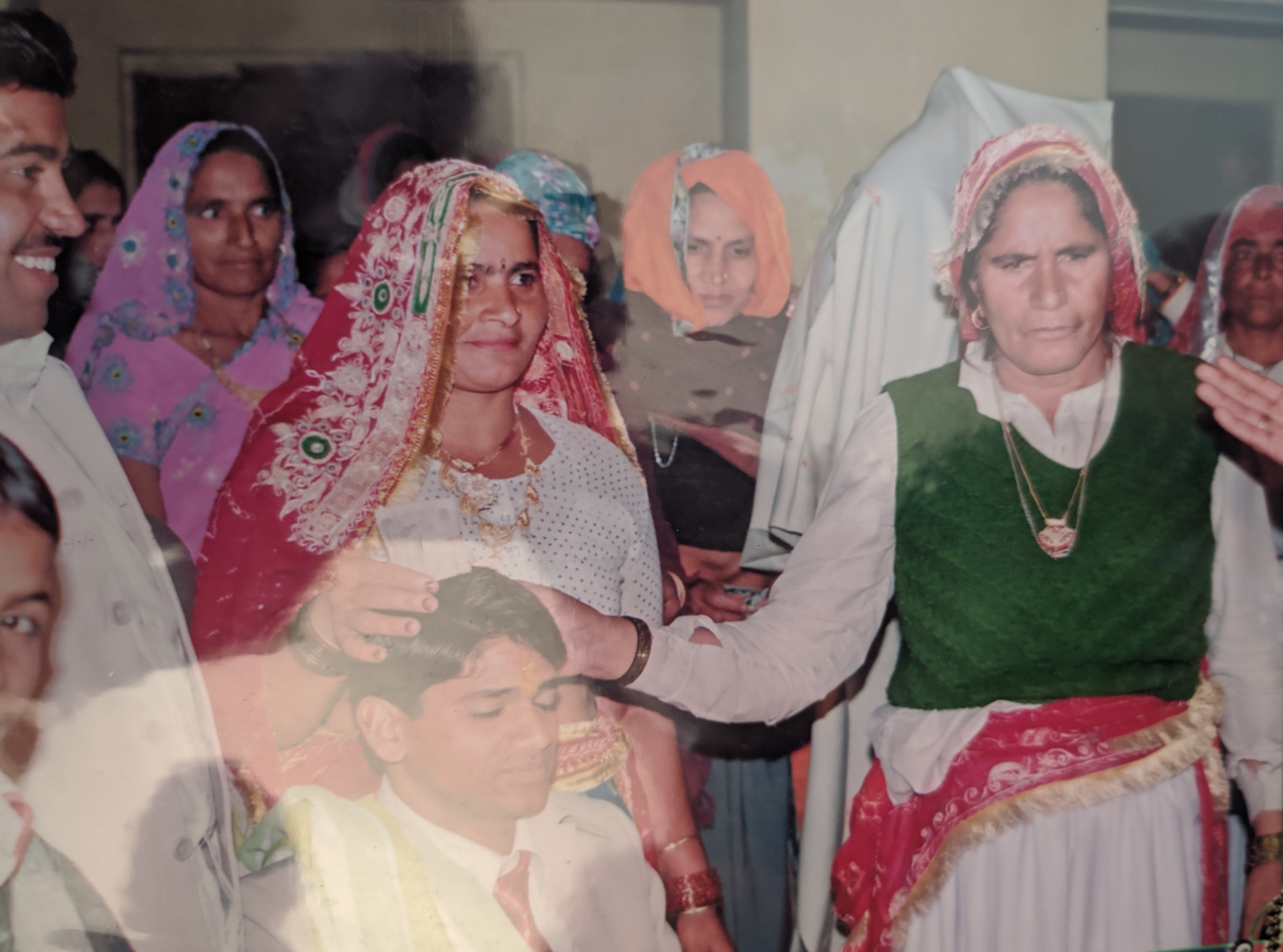 Dadi blessing the groom and bride at wedding celebration